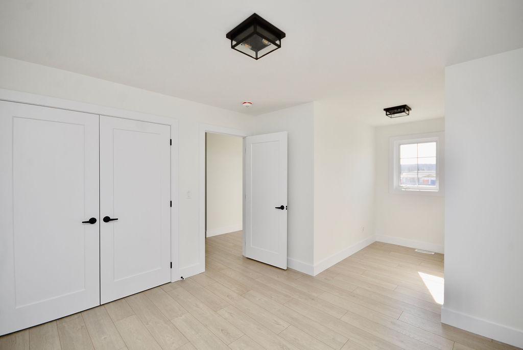 Upstairs large 2nd bedroom with double door closet and small nook.