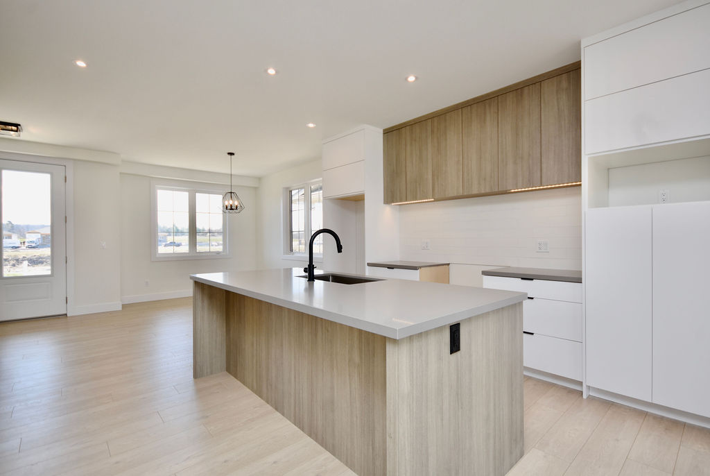 Another view of the large kitchen with lots of cabinets and drawers for storage.